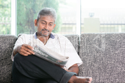 Indian man reading newspaper