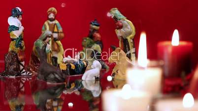 Christmas nativity scene with candles on red