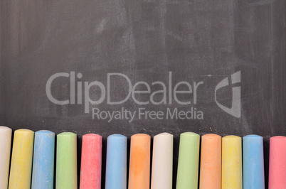 Colorful chalk on blackboard