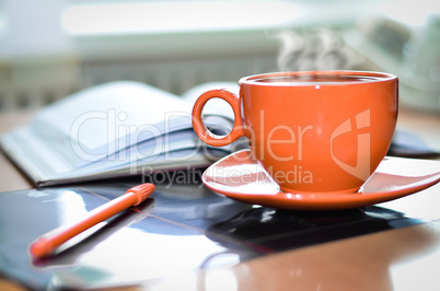 Cup of coffee on the desk in the office