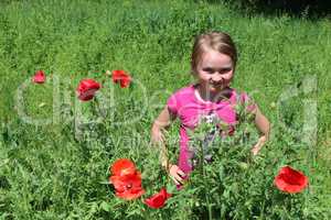 girl standing in the flower-bed with red poppies