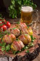 Baked potatoes wrapped in ham
