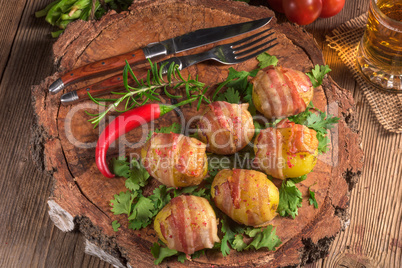 Baked potatoes wrapped in ham