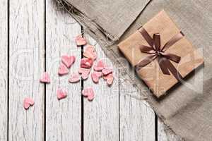 Gift box with heap of small hearts
