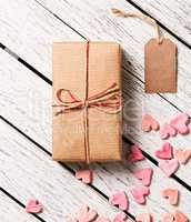 Gift box with blank gift tag and heap of hearts