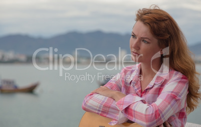 beautiful red-haired girl with a guitar