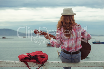 beautiful red-haired girl with a guitar