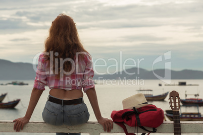 beautiful red-haired girl with a guitar