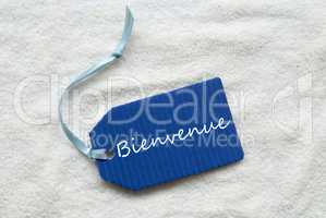 Bienvenue Means Welcome On Blue Label Sand Background