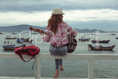 beautiful red-haired girl with a guitar