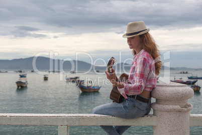 beautiful red-haired girl with a guitar