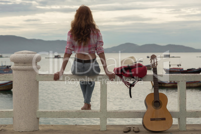 beautiful red-haired girl with a guitar