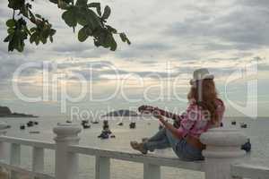 beautiful red-haired girl with a guitar