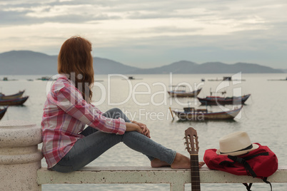 beautiful red-haired girl with a guitar