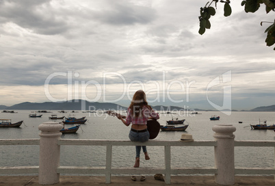 beautiful red-haired girl with a guitar