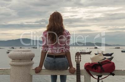 beautiful red-haired girl with a guitar