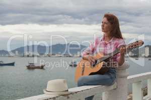 beautiful red-haired girl with a guitar