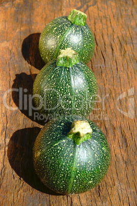 Drei runde Zucchinis in der Reihe hintereinander