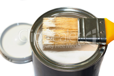 Brush and open paint pot