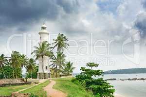 Lighthouse and palm trees