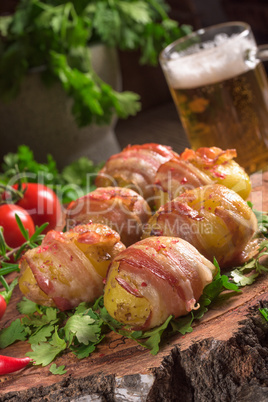 Baked potatoes wrapped in ham