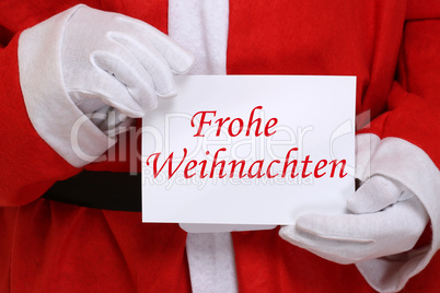 Frohe Weihnachten Weihnachtsmann Nikolaus hält Weihnachtskarte