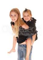 Young pretty girl is piggybacking little brother.