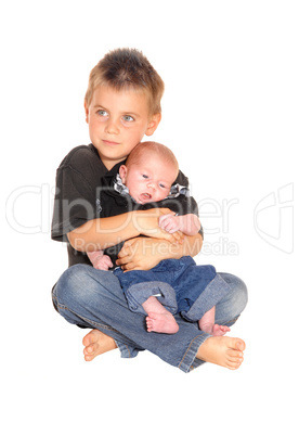 Little boy holding his three weeks old brother.