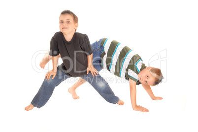 Two little boy's dancing on the floor.