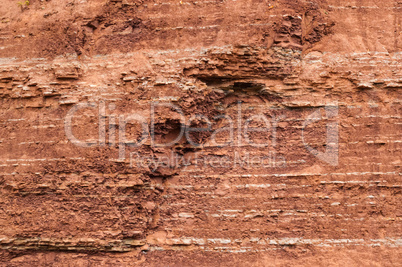 Red sedimentary clay background eroding