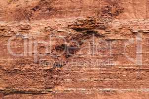 Red sedimentary clay background eroding