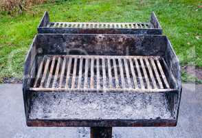 Dirty metal barbecue grill with ashes.