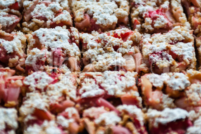 Cut rhubarb cake sprinkled with powdered sugar