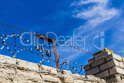 Brick wall with barbed wire