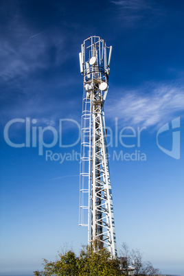 Mast is to accommodate cellular antennas on blue sky background