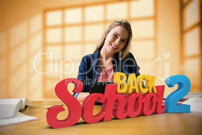 Composite image of student studying in the library with tablet