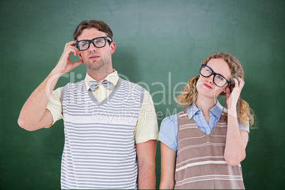 Composite image of geeky hipster couple thinking with hand on te