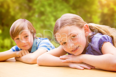 Composite image of cute pupils resting on their arms