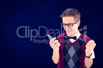 Composite image of excited geeky hipster texting on the phone