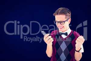 Composite image of excited geeky hipster texting on the phone