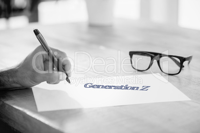 Generation z against side view of hand writing on white page on