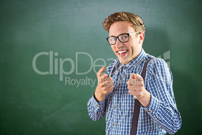 Composite image of geeky hipster pointing at camera