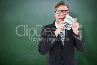 Composite image of geeky businessman pointing to calculator
