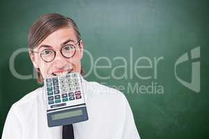 Composite image of geeky smiling businessman biting calculator