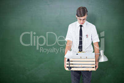 Composite image of fired businessman holding box of belongings