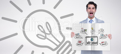 Composite image of businessman showing a book