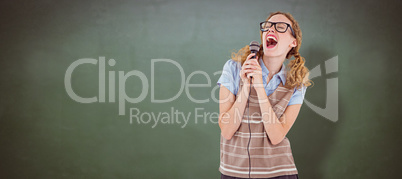 Composite image of geeky hipster woman singing into a microphone