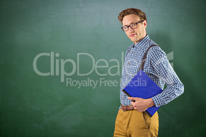 Composite image of geeky student holding a notebook