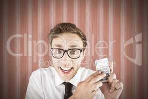 Composite image of geeky businessman using a calculator