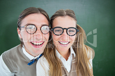 Composite image of geeky hipsters smiling at camera